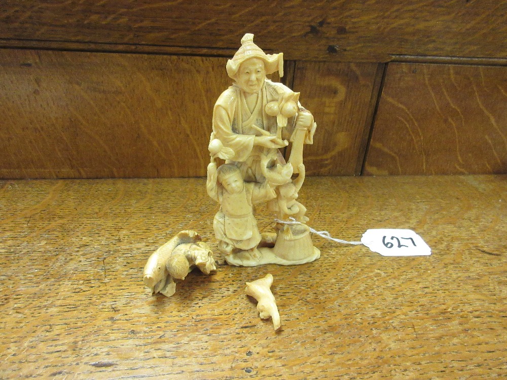 A Japanese ivory Okimono of a FarmerMeiji PeriodStanding holding a pipe surrounded by monkeys and