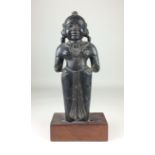 A 17th Century Indian carved blackstone Figure of a Maiden, Gujarat, Wearing earrings and