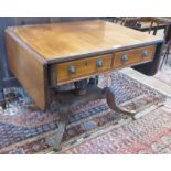 An early 19th Century mahogany Sofa Table fitted two frieze drawers with pineapple carved column and