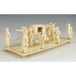 A 19th Century Indian ivory Model of a palanquin group,Bengal, The palanquin suspended by a pole