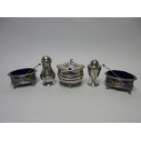 A George III silver Mustard Pot with hinged lid, beaded rim on ball feet, a George I Pepperette,