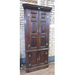 An antique oak Double Corner Cupboard having two pairs of fielded panel doors on plinth base, 6ft