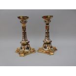 A pair of Royal Crown Derby pillar Candlesticks with shaped circular sconces, tapering column on