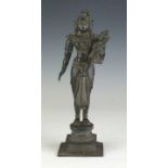 A South Indian bronze Figure of Yashoda and baby Krishna, c 1900, The infant held on her hip,