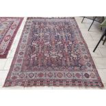 A bordered Shirvan Rug with stylised totem pattern in red etc on a blue ground, 8ft 8in x 5ft 8in