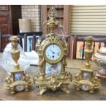 A late 19th Century French gilt metal and porcelain mounted matched Clock Garniture, the circular