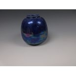 A Ruskin pottery ovoid Vase with blue flambe glazes, an iridescent finish, impressed marks,