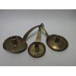 Three early brass Chambersticks, one with D-shaped tray and pierced flat section pierced handle,