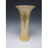 A tall Ruskin trumpet shaped Vase with flared rim, having mottled yellow egg shell iridescent glaze,