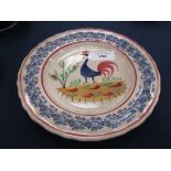 An early 20th Century Llanelly pottery cockerel Platewith a foliate rim, probably painted in a naive