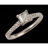 A Diamond single stone Ring corner claw-set asscher-cut stone with brilliant-cut stones to shoulders
