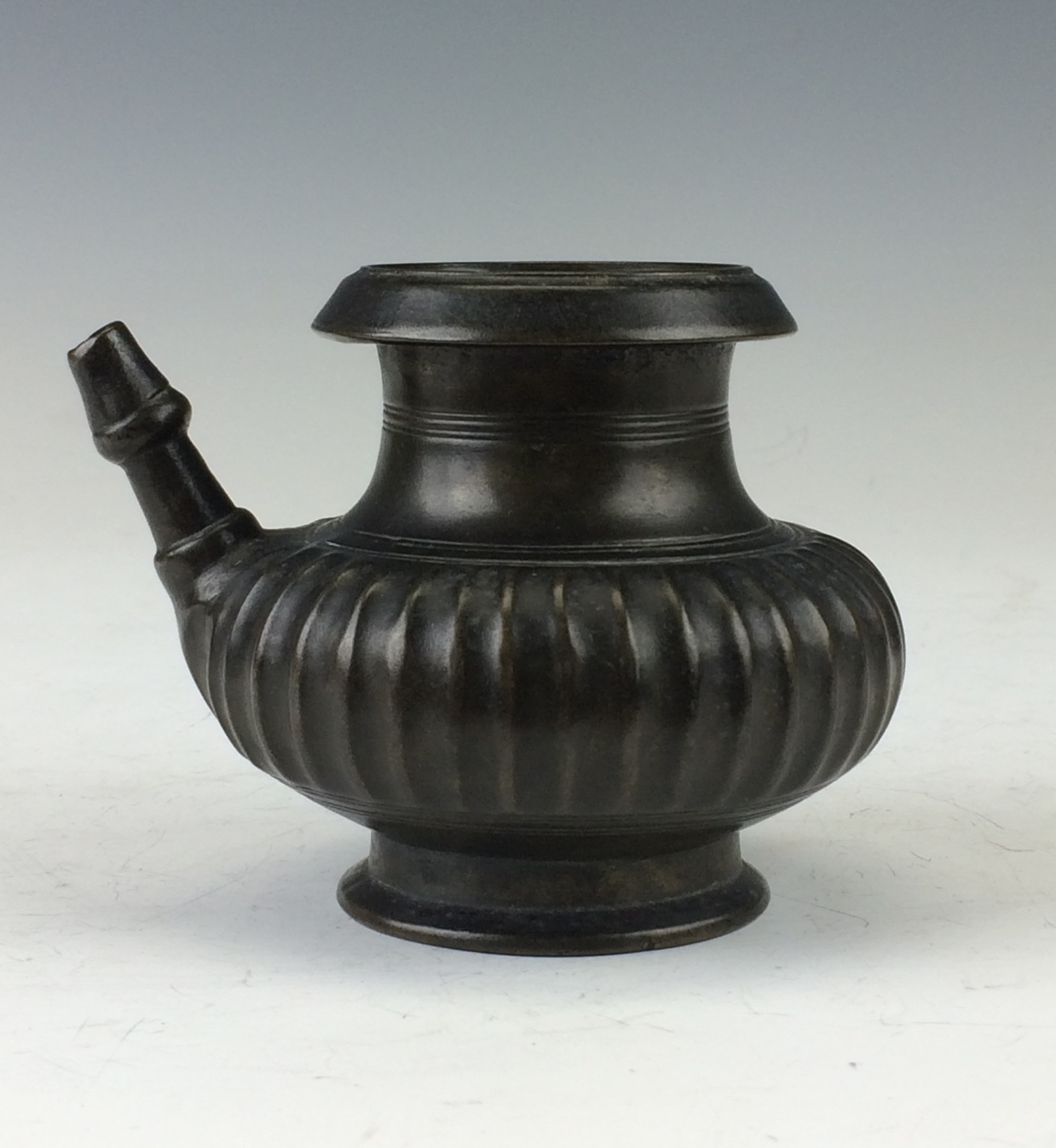 An 18th Century Mughal small bronze spouted Lota, Deccan or South India, With fluted compressed body