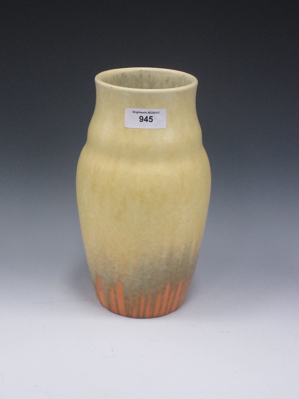 A tall Ruskin pottery Vase with shaped collar, yellow glazed into orange drip glaze to lower