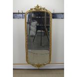 A 19th Century gilt Wall Mirror with floral and scrolled detail to the crest and base, 5ft 4in H x