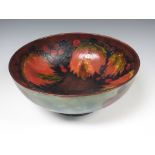 A Moorcroft pottery Bowl berry and floral pattern on a brown ground to interior, green ground on