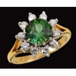 A Green Tourmaline and Diamond Cluster Ring claw-set round-cut tourmaline within a frame of ten