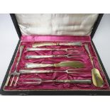 A Russian silver-gilt handled eight piece Serving Set, two with dolphin handles, in case marked
