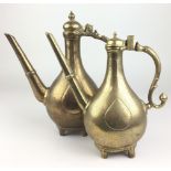 Two 19th Century Mughal brass Ewers,Of pear shape, one dated AH 1282/AD1865-66, beneath an Arabic