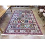 A bordered Persian Carpet the central field with six rows of rectangular floral medallions, stylised