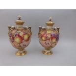 A pair of Royal Worcester lidded two handled Vases, painted peaches, apples, grapes, cherries and