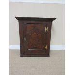 An 18th Century oak Wall Cupboard with single cupid's bow panelled door having floral inlay, 2ft