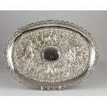 An Indian silver oval Tray,Calcutta,Repousse decorated with a continuous scene of wild animals,