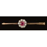 A Red Spinel and Diamond Bar Brooch claw-set round spinel within a frame of nine old-cut diamonds