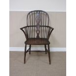 A 19th Century Windsor Wheelback Armchair with elm seat on turned legs with H Stretcher,