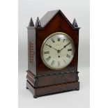 A 19th Century mahogany Bracket Clock with arched top above the circular enamel dial inscribed R.