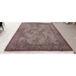 A bordered Persian Carpet the central field with all over palmette and floral design, red, blue,