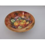 A Coalport circular Bowl painted fruits, signed by P Gosling, on three scroll feet, 10 1/2in D