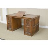 A 19th Century oak gothic revival Desk with inset writing surfaces, one adjustable above pair of