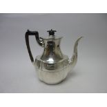 A Victorian silver Coffee Pot of shaped oval form having engraved friezes and ebonised handle,
