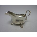 An Edward VIII silver Sauce Boat with leafage scroll handle on ornate feet, Birmingham 1936