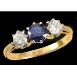 A Sapphire and Diamond three stone Ring claw-set round sapphire between two brilliant-cut