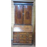 An 18th Century Dutch walnut Bureau Bookcase, the upper section enclosed by two plain doors on