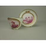 A Kerr and Binns Worcester Cup and Saucer with central pink sepia panels of cherubs within
