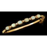An Opal and Diamond hinged Bangle, the front rub-over set six oval opal cabochons with eight-cut