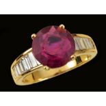 A Ruby and Diamond Ring claw-set round ruby, 3.26cts, between rows of graduated, channel-set