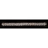 A Diamond Bracelet millegrain-set twenty three brilliant-cut stones in intricate articulated links