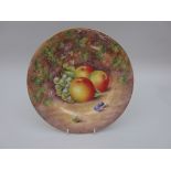 A Royal Worcester Plate with gold rims painted apples and grapes on a mossy ground, signed M