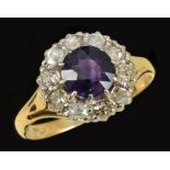 An Amethyst and Diamond Cluster Ring claw-set round-cut amethyst within a frame of ten pavé-set