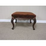 A Victorian walnut framed Dressing Stool with stuff over seat on floral carved cabriole legs