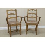 A pair of Acornman oak Elbow Chairs with wavy ladderbacks, shaped arms, leather upholstered drop-