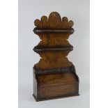 An 18th Century oak Spoon Rack with shaped back and sloping hinged box to base, 23in H