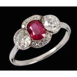 A Ruby and Diamond Ring millegrain-set oval-cut ruby between two old-cut diamonds within bands of