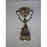 A Continental silver mounted moonstone Wager Cup with figural support and scroll engraving, 4in