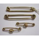 Four 9ct gold Bib Pins, approx 6.45gms