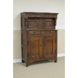 An 18th Century small oak Court Cupboard with carved frieze above a pair of small doors, two