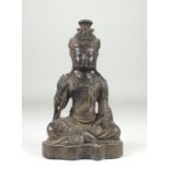 A Chinese Ming style copper alloy Figure of Guanyin, Seated on a shaped base, hands holding a